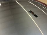 a close up view of a car ' s hood with a remote control