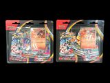 two packs of pokemon trading cards on a black background