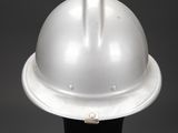 a close up of a white hard hat on a black stand