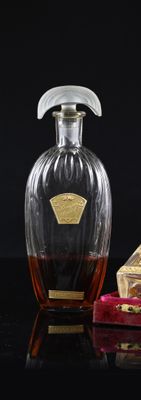 a bottle of liquor and a box of chocolates on a table
