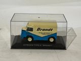 a small blue and yellow van in a clear box