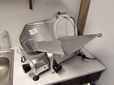 a large slicer sitting on top of a kitchen counter