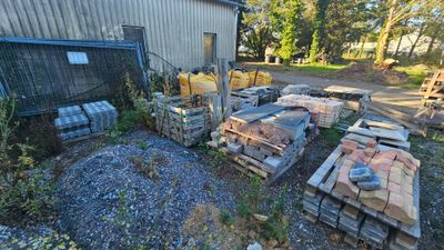 une grande quantité de bois empilé devant un bâtiment