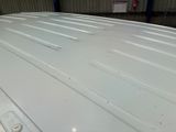 a close up of a white car in a garage