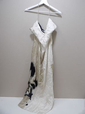 une robe blanche suspendue à un cintre dans une pièce