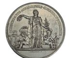 an old silver coin with a statue of a woman holding a bird