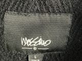 a close up of a wool jacket with a tag on it