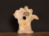 a small piece of pottery on a table with a black background