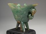 an image of a statue of a bird on a stand