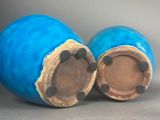 two blue vases sitting next to each other on a table