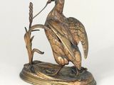 a statue of a bird sitting on top of a table