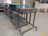 an image of a conveyor belt in a factory with boxes in the background