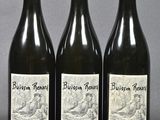three bottles of wine sitting on top of a table next to each other