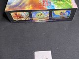 pokemon trading card game in a box on a table next to a price tag