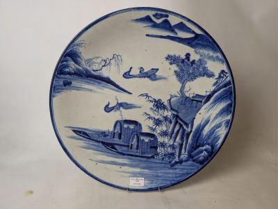 a blue and white plate with a boat on it