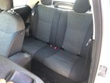 the back seats of a car with a cup holder in the back