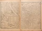 an open book with a drawing of a city on it