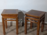 two wooden tables sitting next to each other on a tiled floor