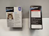 two boxes of decamp for cats sitting on a table