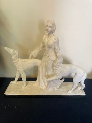 a figurine of a woman and a dog on a table