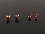 three gold heart shaped stud earrings with a pink stone in the middle