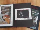 two books that are open on a wooden table