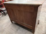 a wooden cabinet with a marble top in a warehouse