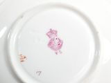 a white plate with a pink design on it