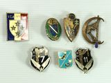 several different types of badges are displayed on a white surface
