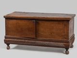 an old wooden chest sitting on top of a wooden table