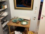 a picture of a room with a table and a painting on the wall