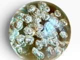 a close up of a glass object on a white surface