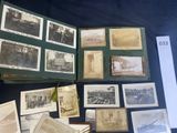 several old photographs of people and vehicles are displayed on a table