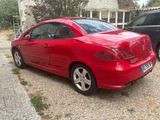 a picture of a red car parked in front of a house