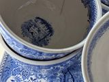 four blue and white bowls sitting on top of each other
