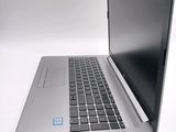 a silver laptop with a black keyboard on a white surface