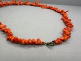 un gros plan d'un collier orné de perles orange posé sur une table
