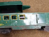 a green toy train car with a box on top of it