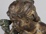 bronze statue of a boy with a bird in his hand
