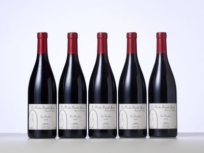 quatre bouteilles de vin sont alignées sur une table