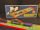 a toy train and a toy car on a table next to a box