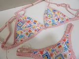 a pink and white bikini top with a red and white striped bottom