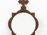 an old wooden mirror with a cross on top of it