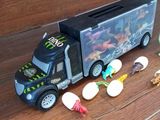 a toy truck that is sitting on the floor next to other toys