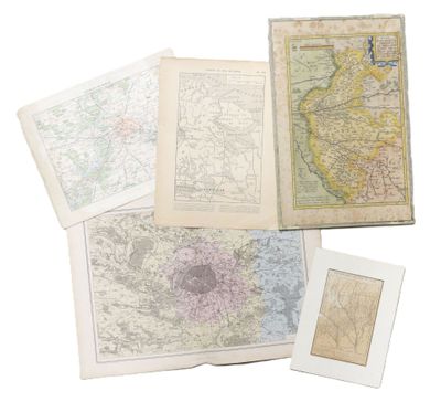 several old maps of different countries are displayed on a white surface