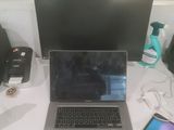 a laptop computer sitting on top of a white desk