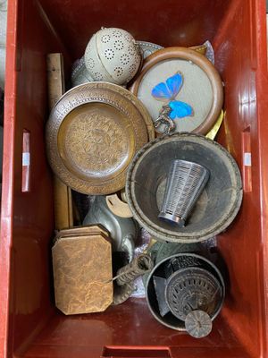 a red box filled with assorted items on the floor