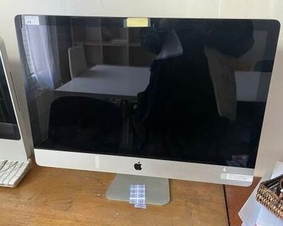 a computer monitor sitting on a desk next to a keyboard and mouse