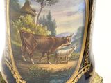a vase with a picture of a cow on it