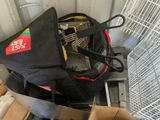 a black bag that is sitting on top of a pile of boxes